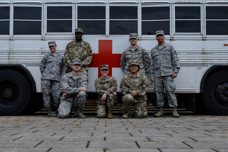 A group of U.S. Air Force service members from the 86th Aerospace Medicine Squadron pose in front of a medical transport shuttle at Ramstein Air Base, Germany, Oct. 9, 2019. The Airmen were part of a larger group that welcomed wounded warriors who visited the base a week before. (U.S. Air Force photo by Airman 1st Class Jennifer Gonzales)