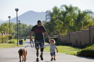 Davey Lind walking with his son and dog