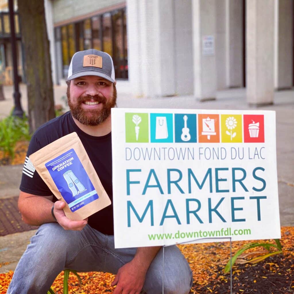 A man at the farmers market promoting operation coffee