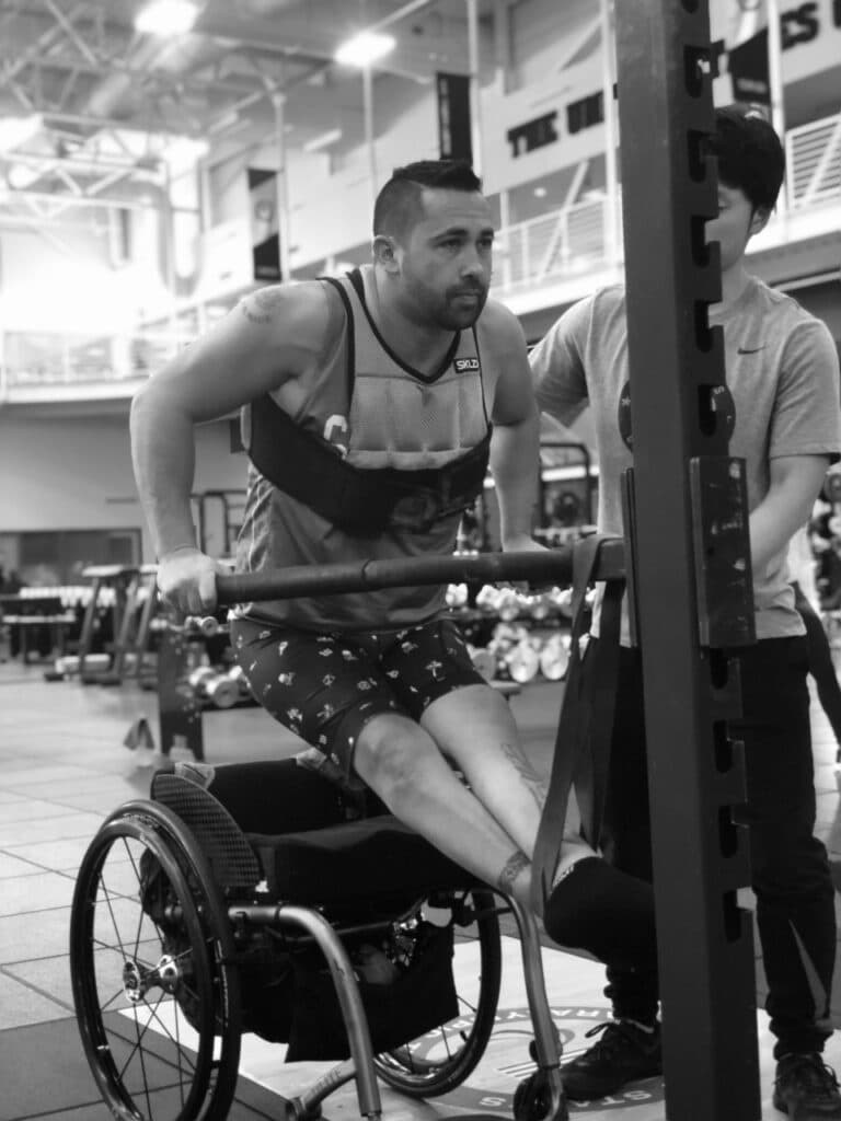 man working out and in a wheelchair